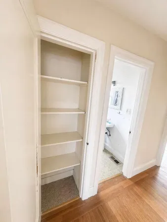 a view of walk in closet with empty racks