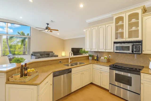 a kitchen with a sink stove and cabinets