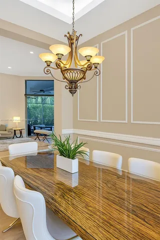 a view of a dining room with furniture and a chandelier
