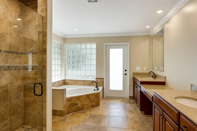 a bathroom with a tub sink and mirror