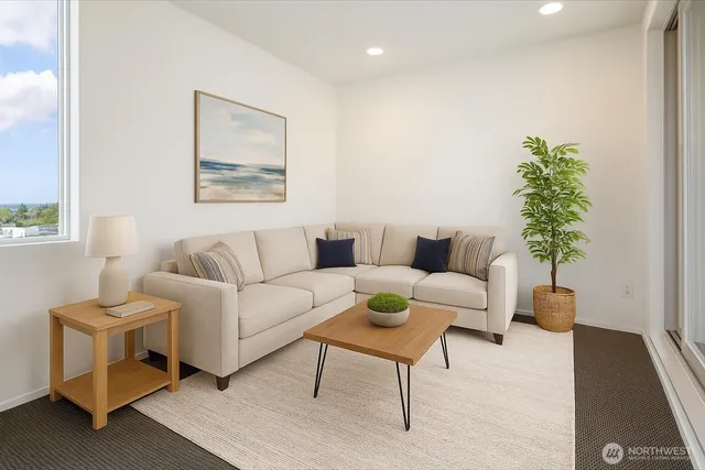 a living room with furniture and a potted plant