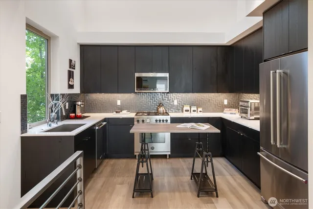 a kitchen with a sink appliances and cabinets