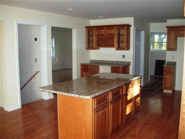 24 South Martin Road Amesbury, MA 01913 - Photo 3 of 8 a kitchen with stainless steel appliances granite countertop a sink and a refrigerator