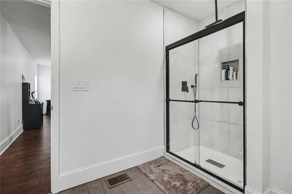 a bathroom with a glass shower door