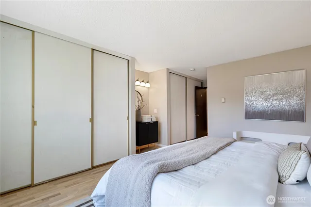 a bedroom with a bed and a painting on the wall