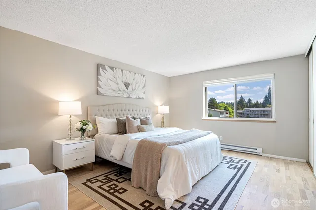 a bedroom with a large bed and a window