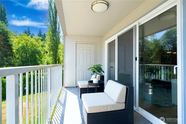 a balcony view with a seating space