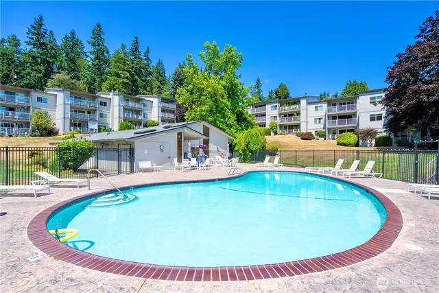 a view of a swimming pool with a yard