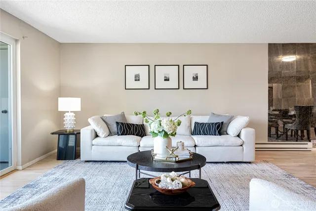 a living room with furniture and a potted plant