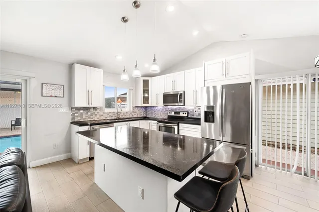 a view of room with ceiling fan and window