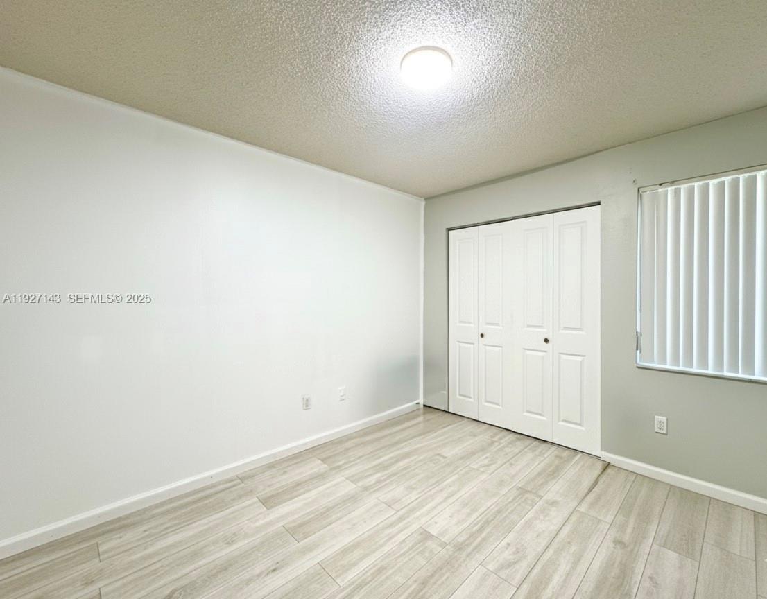 14145 Southwest 100th Terrace Miami, FL 33186 - Photo 12 of 15 wooden floor in an empty room
