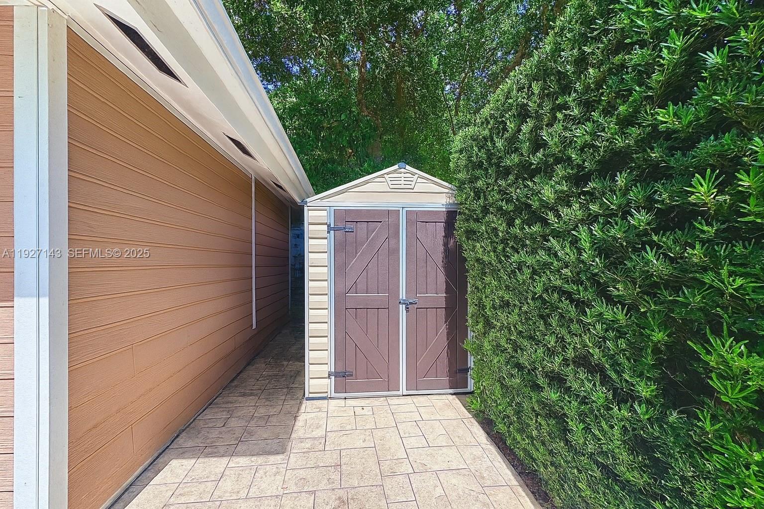 14145 Southwest 100th Terrace Miami, FL 33186 - Photo 14 of 15 a front view of a house with a garden