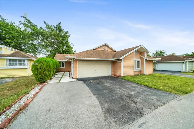 a view of a house with a yard and garage