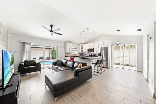a dining room with furniture and a floor to ceiling window