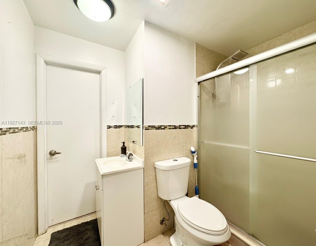 14145 Southwest 100th Terrace Miami, FL 33186 - Photo 10 of 15 a white toilet sitting next to a bathroom sink