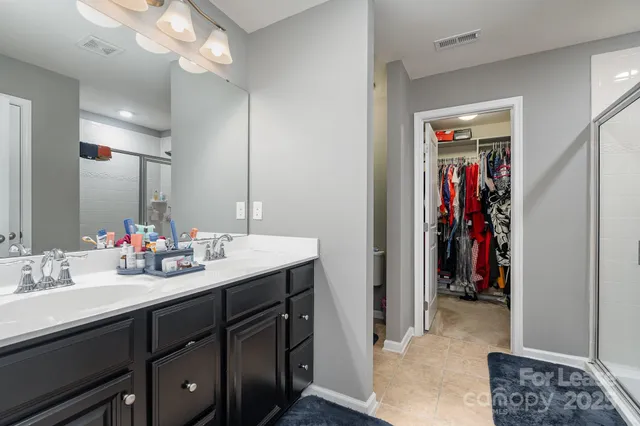 a bathroom with a sink vanity and a mirror