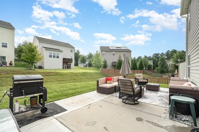 a view of a patio with couches chairs and a yard