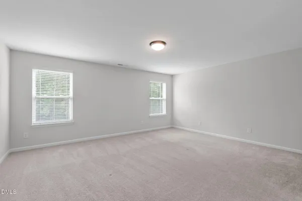 a view of room with window and wooden floor