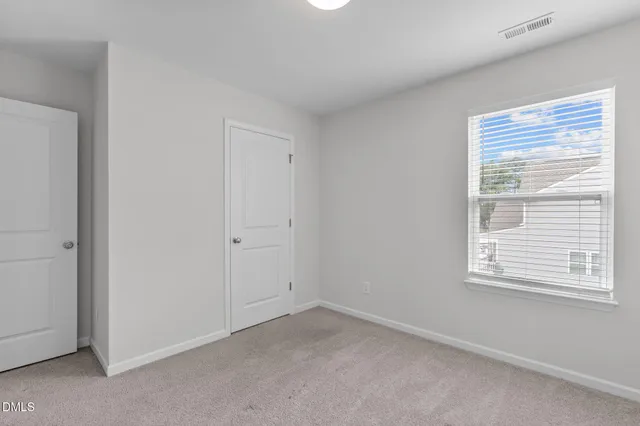 a view of an empty room and closet area