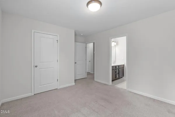 a white bath tub sitting next to a white toilet and vanity