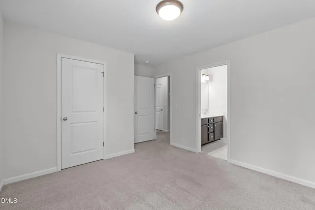a white bath tub sitting next to a white toilet and vanity