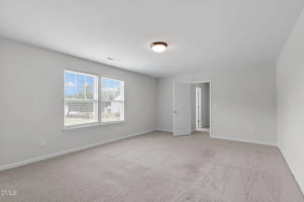 an empty room with closet area