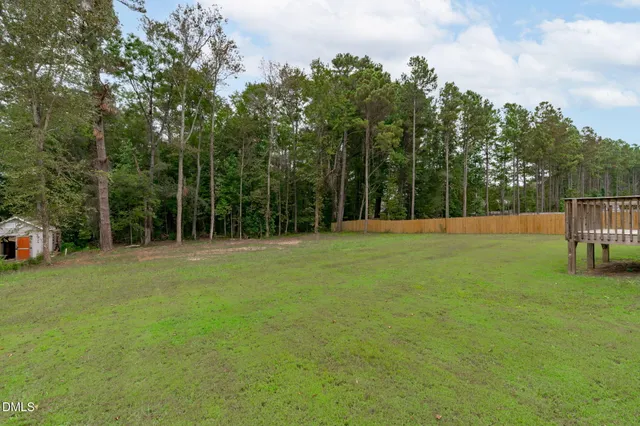 a bathroom with a granite countertop toilet a sink and a window