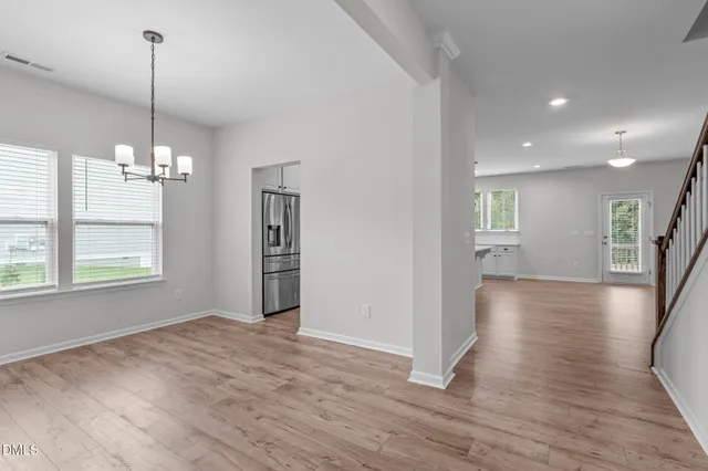 a view of a room with wooden floor and window