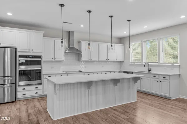 a large kitchen with lots of counter space sink and appliances