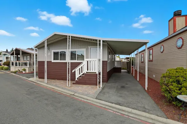 a view of a house with wooden fence