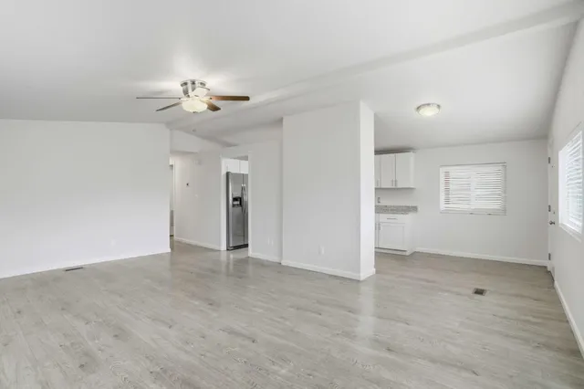 wooden floor in an empty room with a window