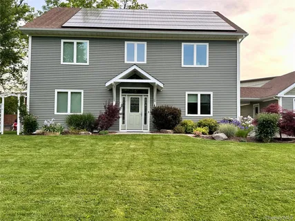 a front view of a house with a yard
