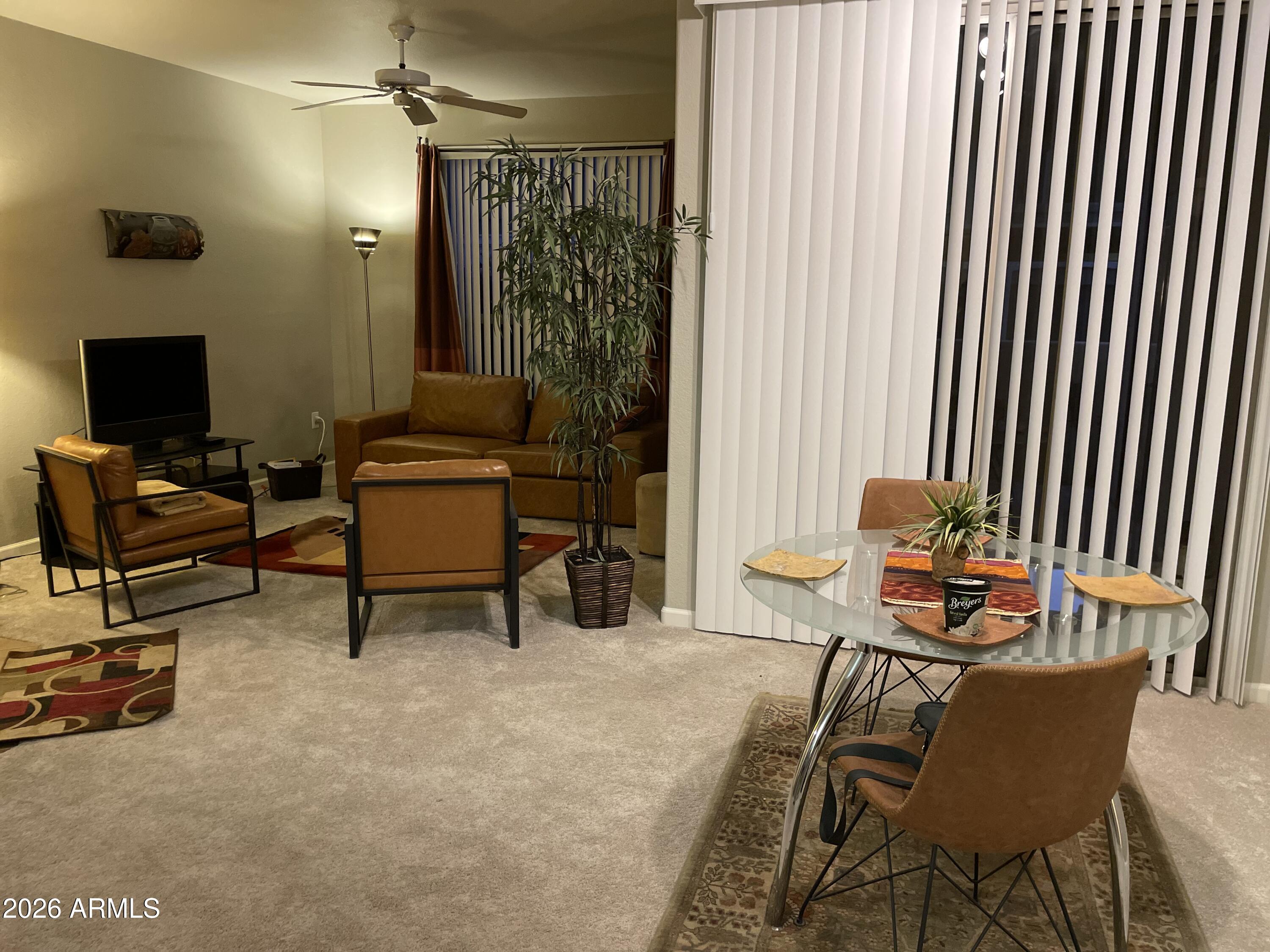 5303 North 7th Street, Unit 113 Phoenix, AZ 85014 - Photo 12 of 21 a living room with furniture and a flat screen tv