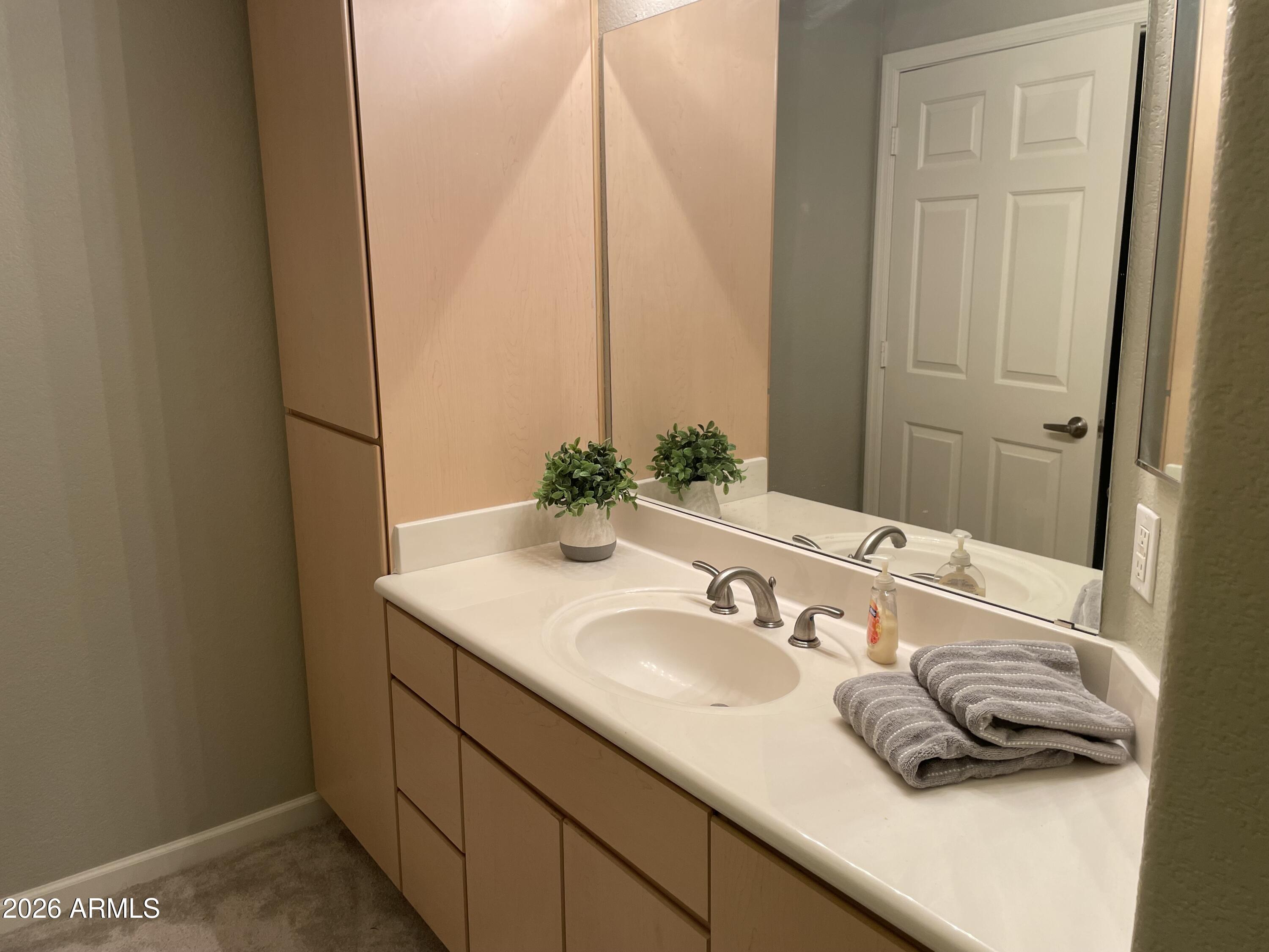 5303 North 7th Street, Unit 113 Phoenix, AZ 85014 - Photo 19 of 21 a bathroom with a sink and a mirror