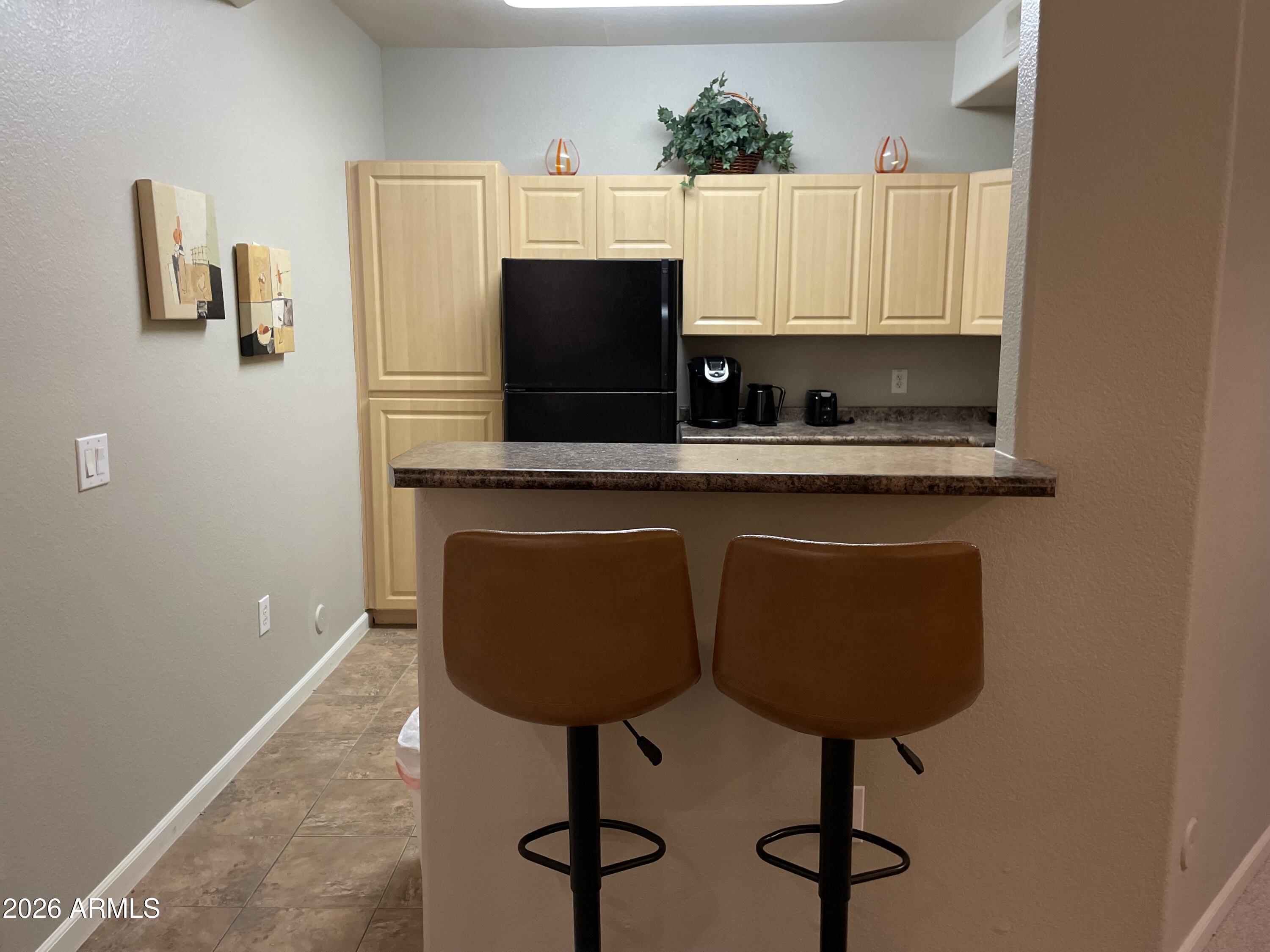 5303 North 7th Street, Unit 113 Phoenix, AZ 85014 - Photo 6 of 21 a kitchen with stainless steel appliances a sink and a refrigerator