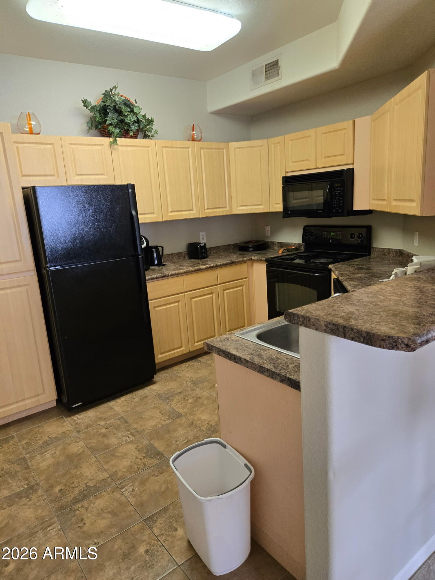 5303 North 7th Street, Unit 113 Phoenix, AZ 85014 - Photo 8 of 21 a kitchen with stainless steel appliances granite countertop a sink a stove a microwave a refrigerator and cabinets