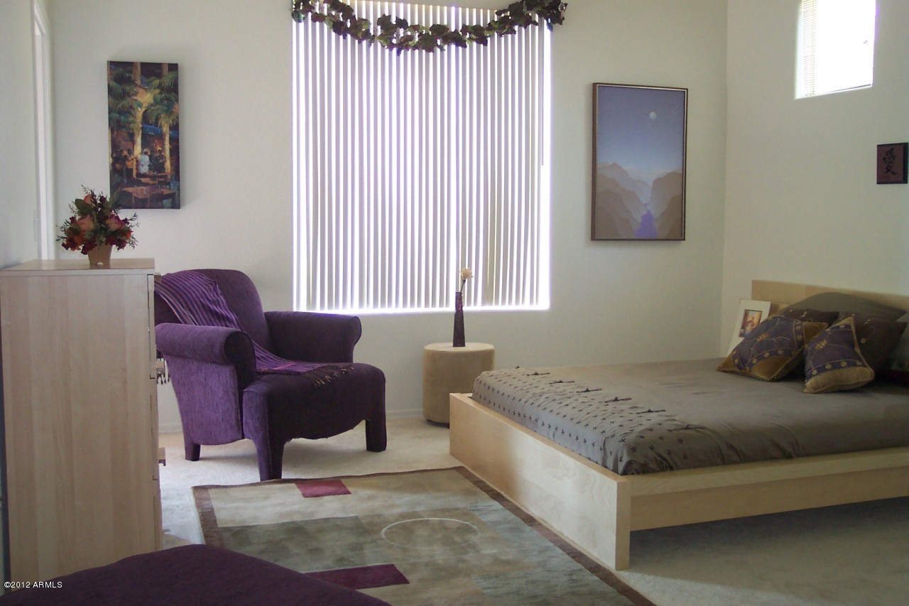 5303 North 7th Street, Unit 113 Phoenix, AZ 85014 - Photo 9 of 21 a bedroom with a bed and a couch