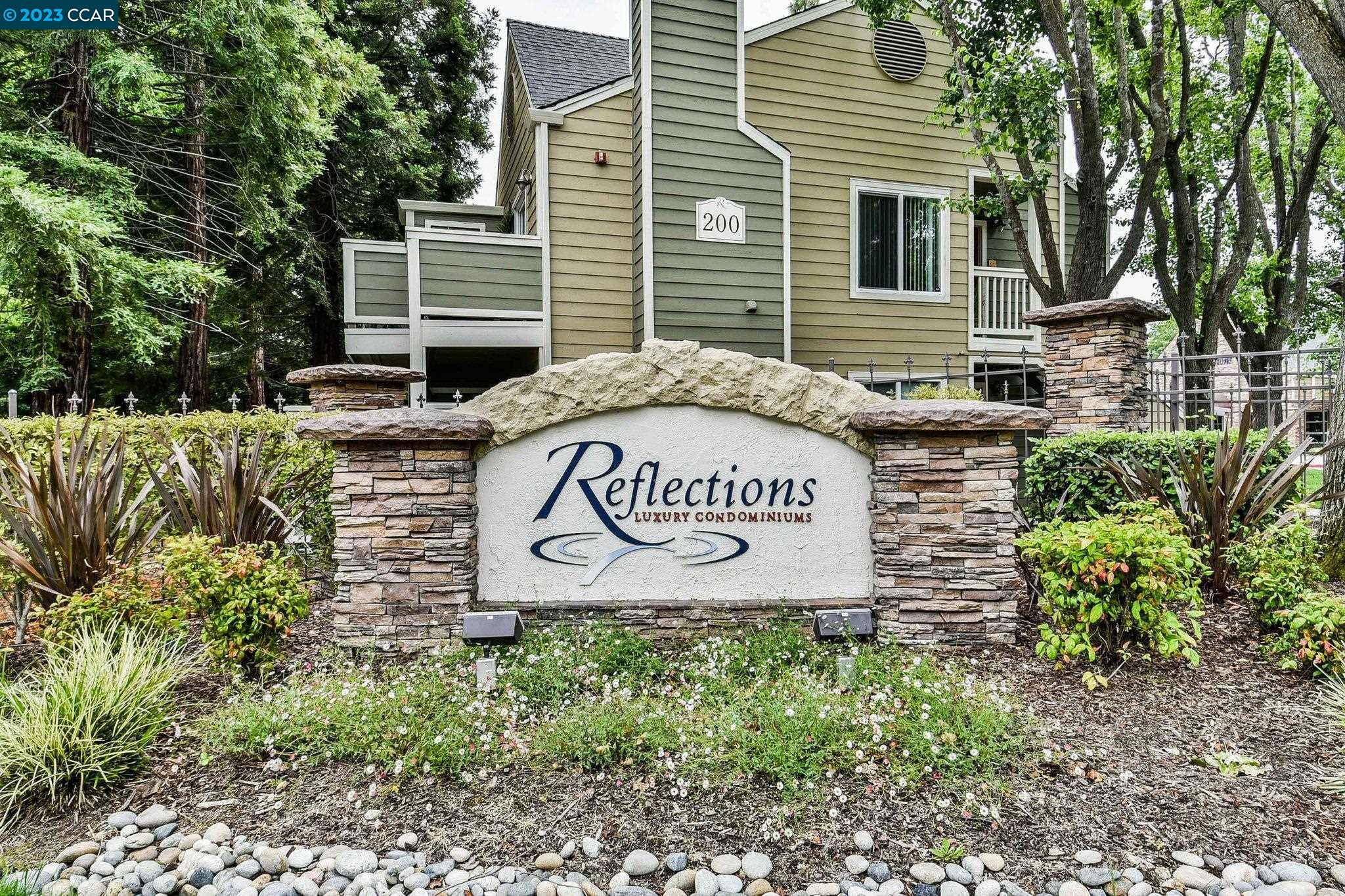 140 Reflections Drive, Unit 12 San Ramon, CA 94583 - Photo 1 of 1 a sign that is sitting on a brick wall