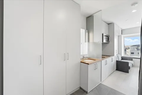 a kitchen with stainless steel appliances granite countertop a sink and a microwave