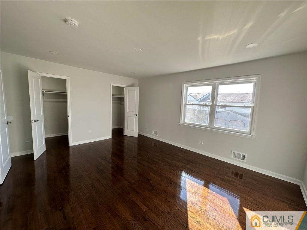 3703 Hana Road Edison, NJ 08817 - Photo 42 of 55 a view of an empty room with wooden floor and a window
