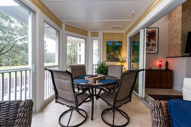 a living room with furniture and a floor to ceiling window