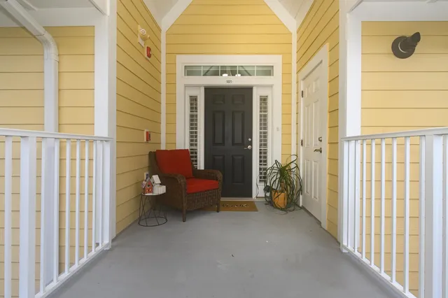 a living room with furniture and a lamp