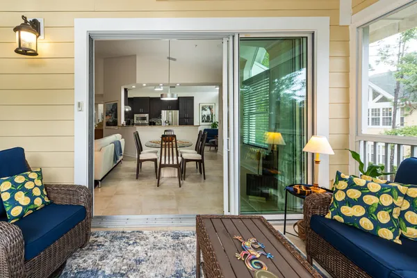 a view of a hallway with bathroom and wooden floor