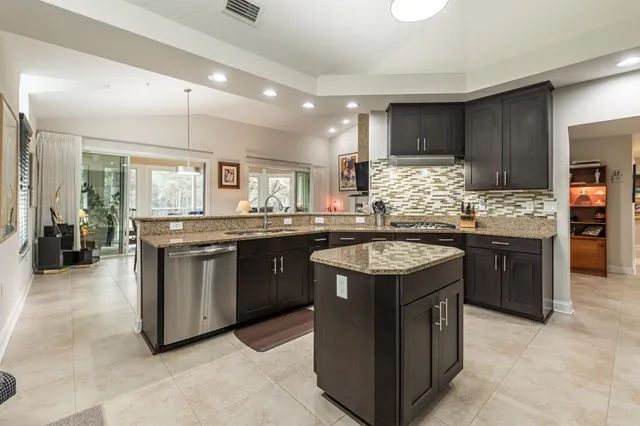 a bathroom with a granite countertop sink a toilet and shower
