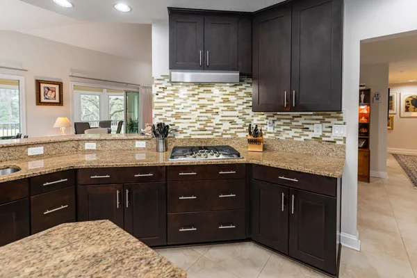 a bedroom with a bed and a lamp on dresser