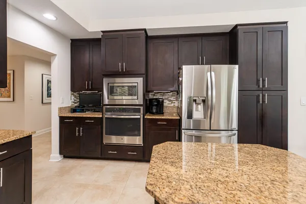 a bathroom with a double vanity sink toilet and a mirror