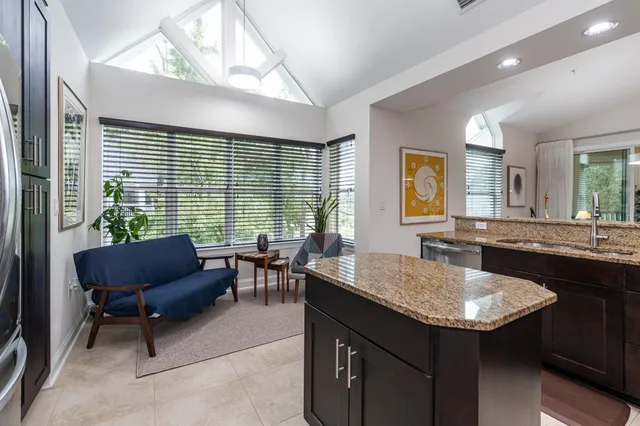 a view of a livingroom with workspace and a window