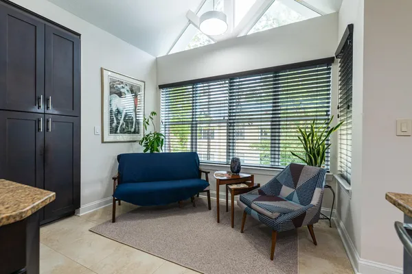 a spacious bathroom with a granite countertop sink and a mirror