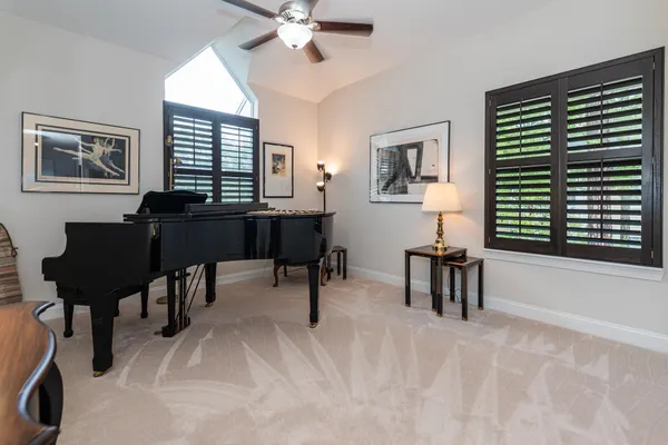 a front view of a house with a yard and potted plants