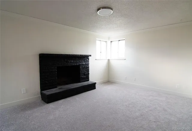an empty room with a fireplace